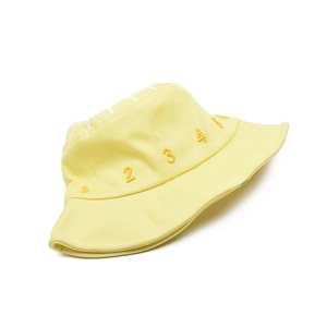 Detail of yellow cotton canvas sun hat featuring numeric embroidery and English text