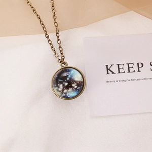 Detailed close-up of retro luminous galaxy pendant with vintage bronze alloy chain