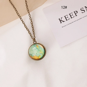 Vintage bronze luminous world map pendant necklace with glass dome on white textile