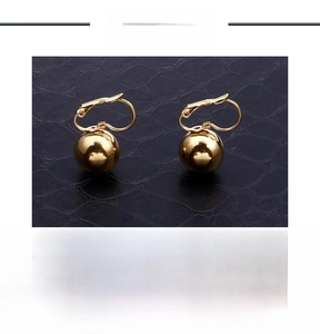 Detail of polished gold ball earrings with French hooks in 15g stainless steel