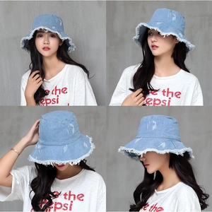 Detail view of light blue denim bucket hat with frayed edges shown in multiple angles