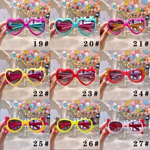 Kids heart shaped sunglasses collection with polka dot frames and bow decoration