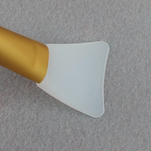 Professional silicone face mask brush with white applicator head and gold handle