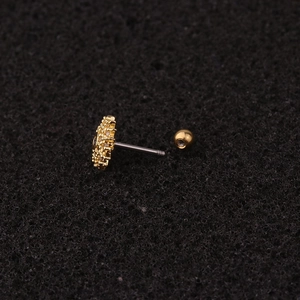 Macro shot of gold zircon cartilage stud earring with stainless steel threaded back bar