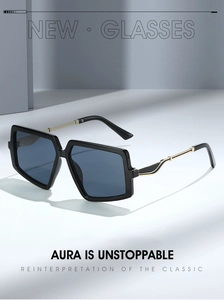 Detail of square oversized sunglasses with black frame and golden metal temples