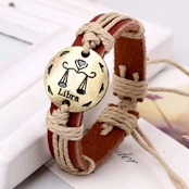 Macro detail of Libra zodiac bronze charm on woven brown leather and jute rope bracelet
