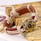 Macro view of retro braided leather bracelet with bronze Cancer zodiac charm and rope detail