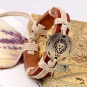 Detailed macro of a braided leather Leo zodiac bracelet with a round metal charm