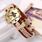 Macro shot of brown leather Sagittarius bracelet with engraved gold-tone metal charm