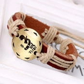 Close-up of woven brown leather bracelet with an antique bronze Virgo zodiac charm