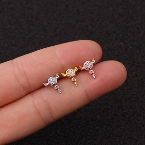 Detailed view of three winged key cartilage earrings in silver, gold, and rose gold finishes