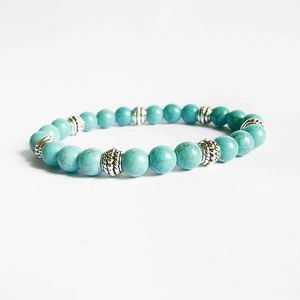 Close-up of 8mm turquoise beaded bracelet with patterned silver alloy spacer beads