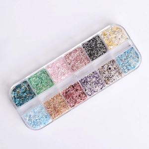 Top view of 12-slot storage box with colorful iridescent nail art shell flakes and sequins