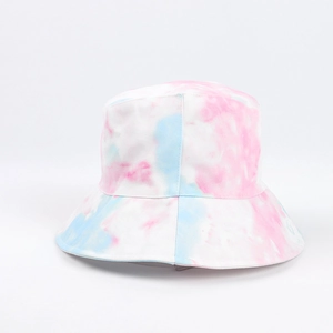 Detail shot of the pastel tie-dye fabric texture and stitching on the bucket hat