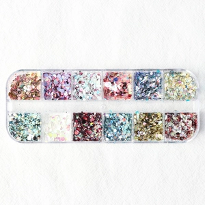 Detailed top view of 12-slot storage box with colorful mixed nail glitters and sequins
