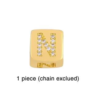 Detail of square gold-plated letter N pendant with micro-pave cubic zirconia crystals
