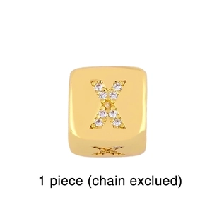 Detail of gold cube charm with crystal rhinestone letter X inlay for DIY bracelets