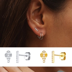 Macro detail of S925 sterling silver bar stud earrings in gold and silver finish