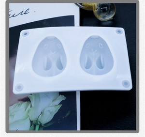 Macro detail of white silicone mold featuring cartoon rabbit character relief designs