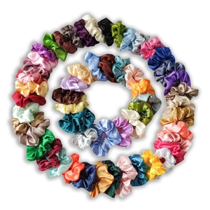 Polished satin scrunchies set in various colors arranged in a spiral circle pattern