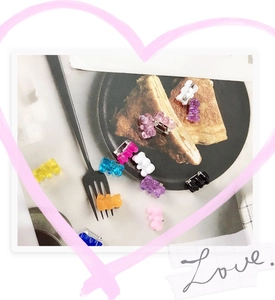 Detailed view of colorful resin gummy bear hair clips scattered on a decorative tray