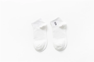 Close-up of white cotton ankle socks with a cute gray kitten embroidery detail