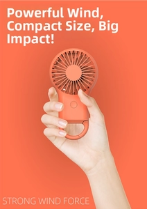 Detail of orange portable mini fan showing hand-held size and mountaineering hook