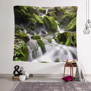 Bohemian wall tapestry featuring a lush green forest waterfall on a white brick wall
