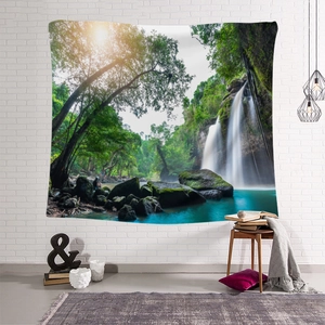 Detail of forest waterfall tapestry on white brick wall with cozy home decor and armchair