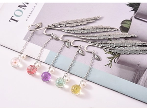 Set of five silver feather bookmarks featuring glass dried flower pendants and pearls