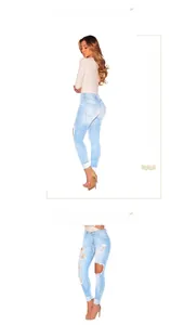 Detail view of high-waist ripped skinny jeans in light blue denim with distressed knees