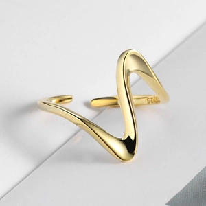 Macro shot of S925 silver stamp on gold wave textured minimalist open ring