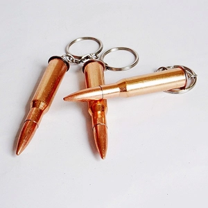 Detailed view of three metallic bronze bullet-shaped keychains with realistic luster