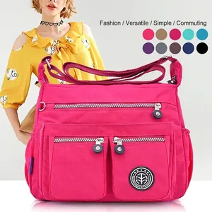 Waterproof rose red nylon crossbody bag with multiple zip pockets and adjustable strap