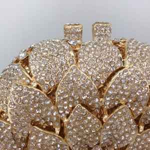 Golden sunflower evening clutch bag featuring intricate crystal pavé and lotus petal design