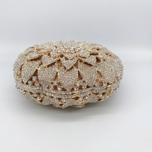 Detail of the golden sunflower evening clutch with hand-set sparkling crystals