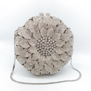 Macro detail of silver sunflower evening bag with handset rhinestones and metal chain