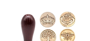 Detail of solid brass wax seal stamp heads with tree of life, rose, and crown motifs