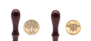 Detailed view of tree of life and bee patterns on solid brass wax seal heads