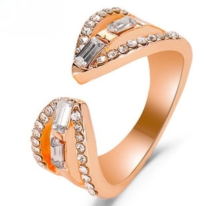 Close-up of rose gold wave ring with baguette and round cut cubic zirconia stones