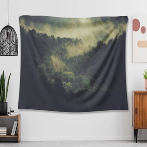 Detail of forest mist wall tapestry hanging in a modern living room setting