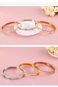 Detail of 6mm stainless steel bangles with white shell inlay in gold, silver and rose gold