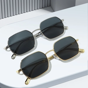 Minimalist hexagonal metal sunglasses set in gold and silver frames with dark grey lenses