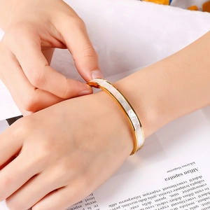 Minimalist gold-plated stainless steel bangle with elegant white pearl inlay for women