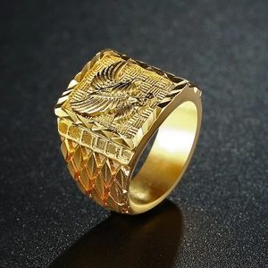 Macro shot of gold-plated square ring featuring detailed eagle relief and textured band