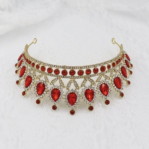 Detail of a golden Baroque bridal tiara with red teardrop gems and clear crystals
