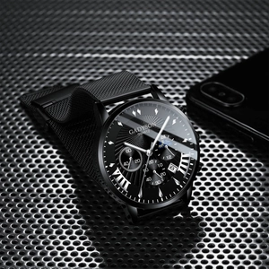 Detail of Gadyson black quartz watch with Milanese band on industrial mesh surface