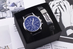 Close-up of Geneva men's blue dial watch and black leather bracelet in a gift box