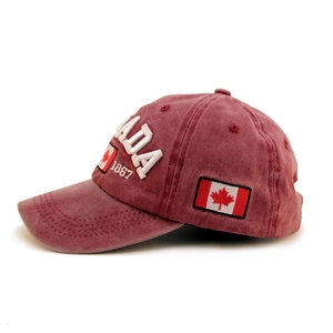 Detail of burgundy washed cotton baseball cap with Canadian flag patch and embroidery