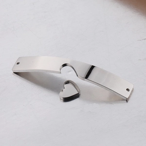 Detailed macro view of heart charm and curved stainless steel metal connector for bracelets